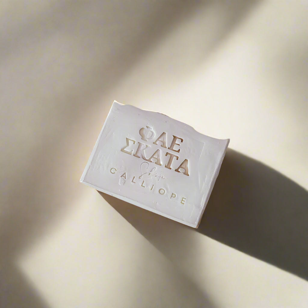 a white bar of soap with branding on a gray background
