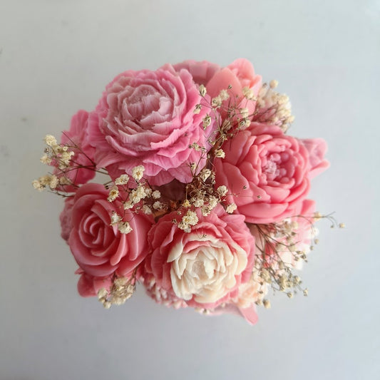 Pink and white flower arrangement on a light gray background