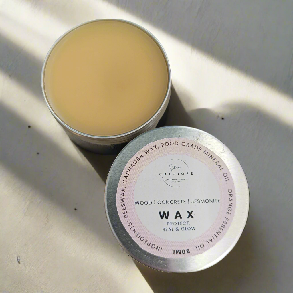 Tin of sealer wax with visible labels on a textured surface