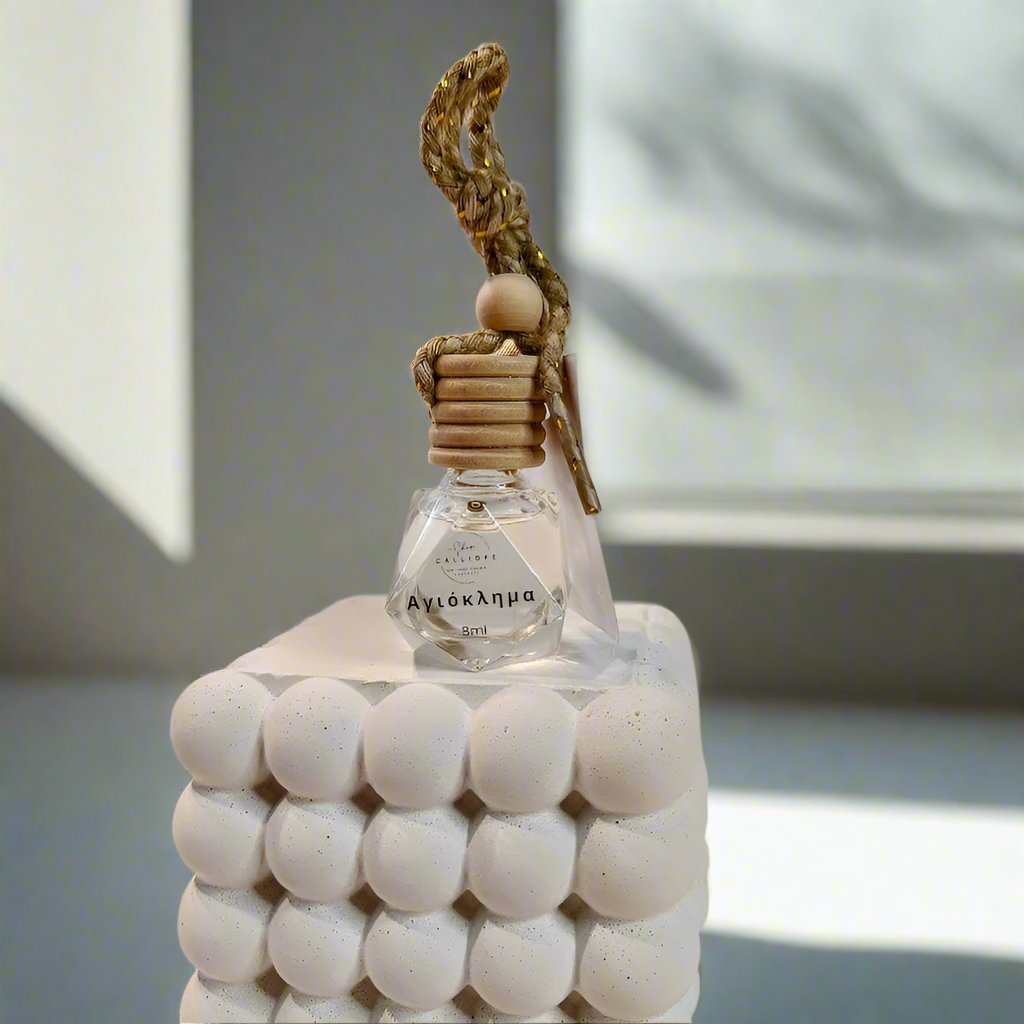 honeysuckle scented diffuser with decorative top on a plain background