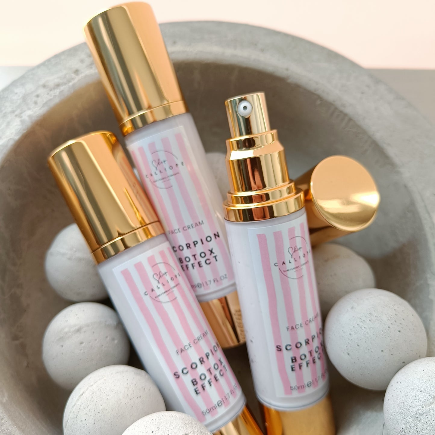 A pump bottle of Scorpion Botox Effect face cream with a gold cap, labeled for anti-wrinkle and moisturizing benefits.