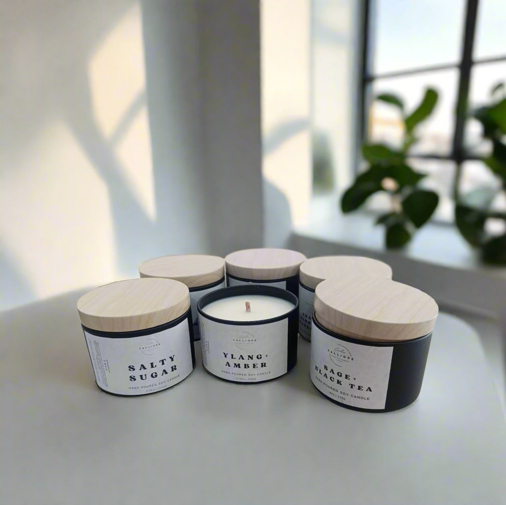 Set of five candles with wooden lids on a white background