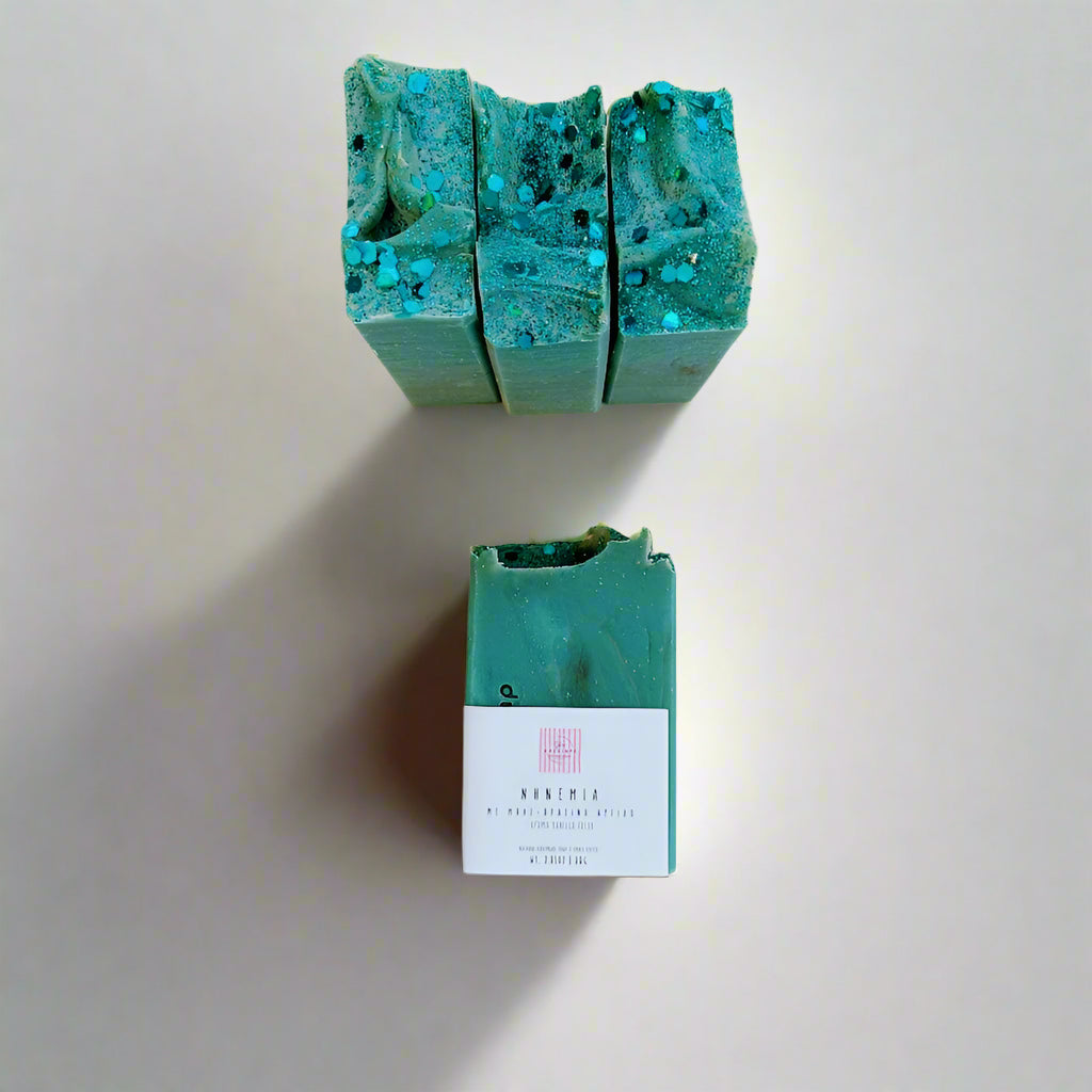 Green soap bars with a label on a light gray surface