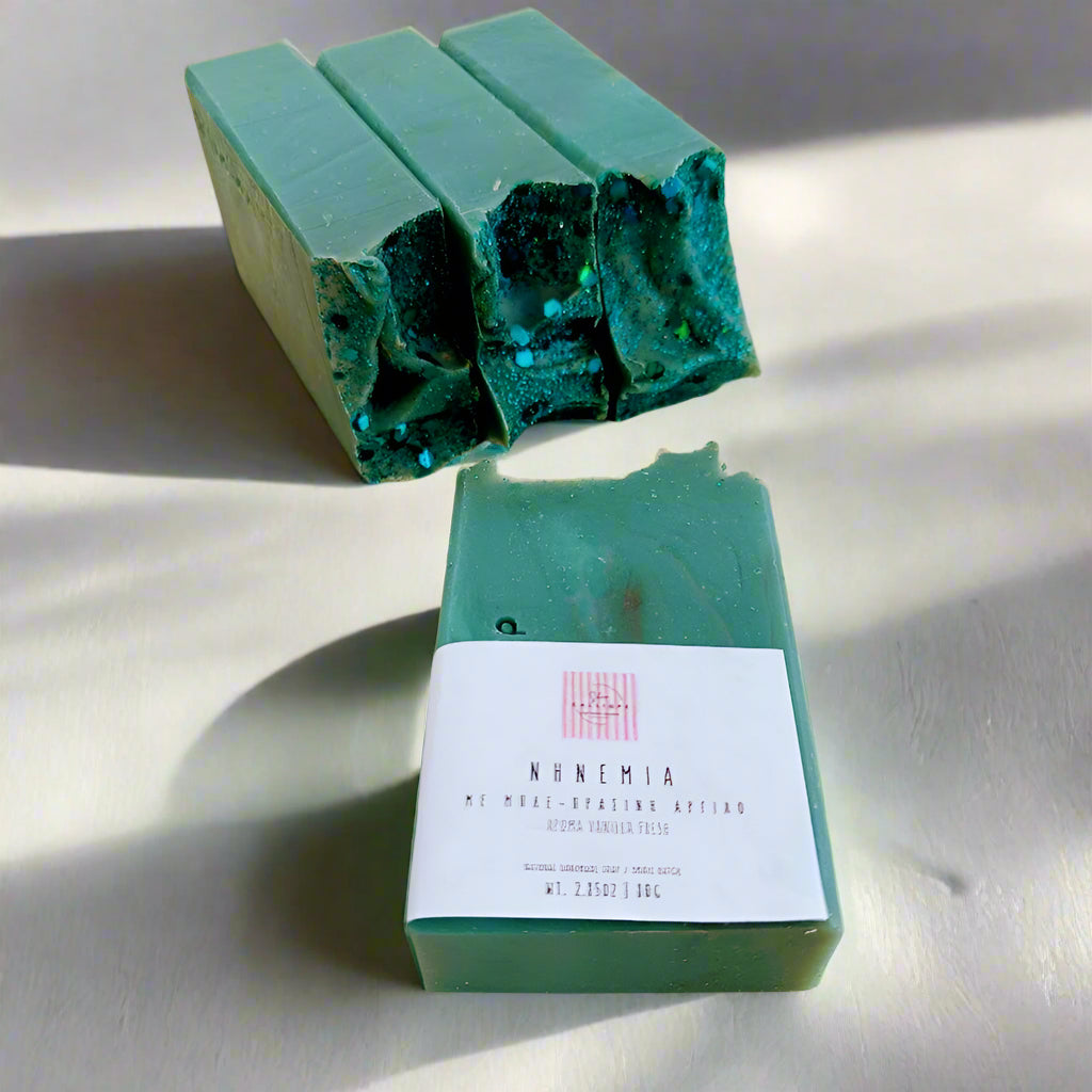 Green soap bars with a label on a beige surface