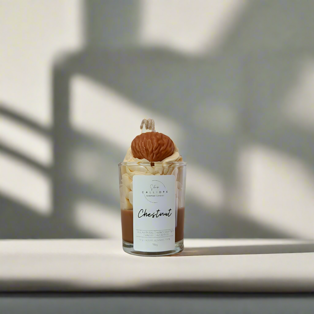 Candle shot with a chestnut on top and a label on a light background