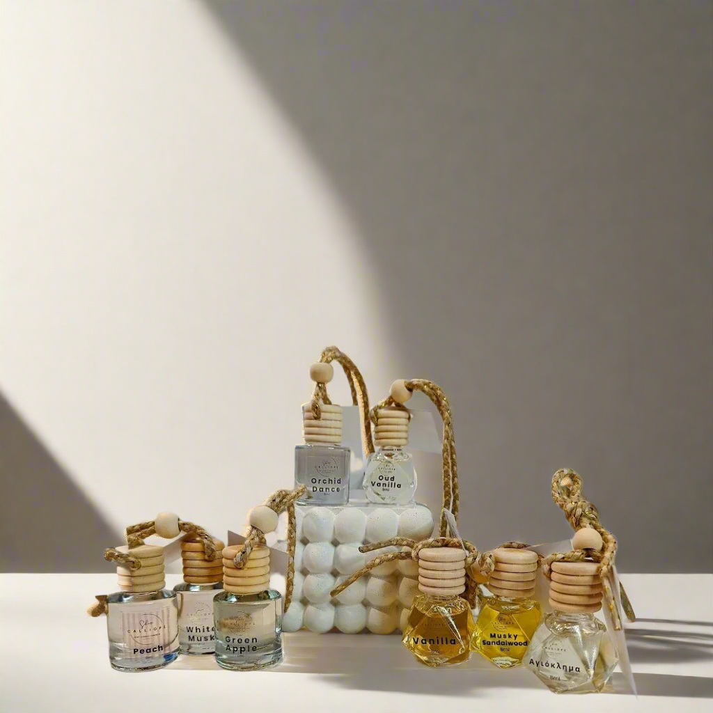 A collection of car diffusers with wooden reeds and bead-like details, displayed on a neutral background.