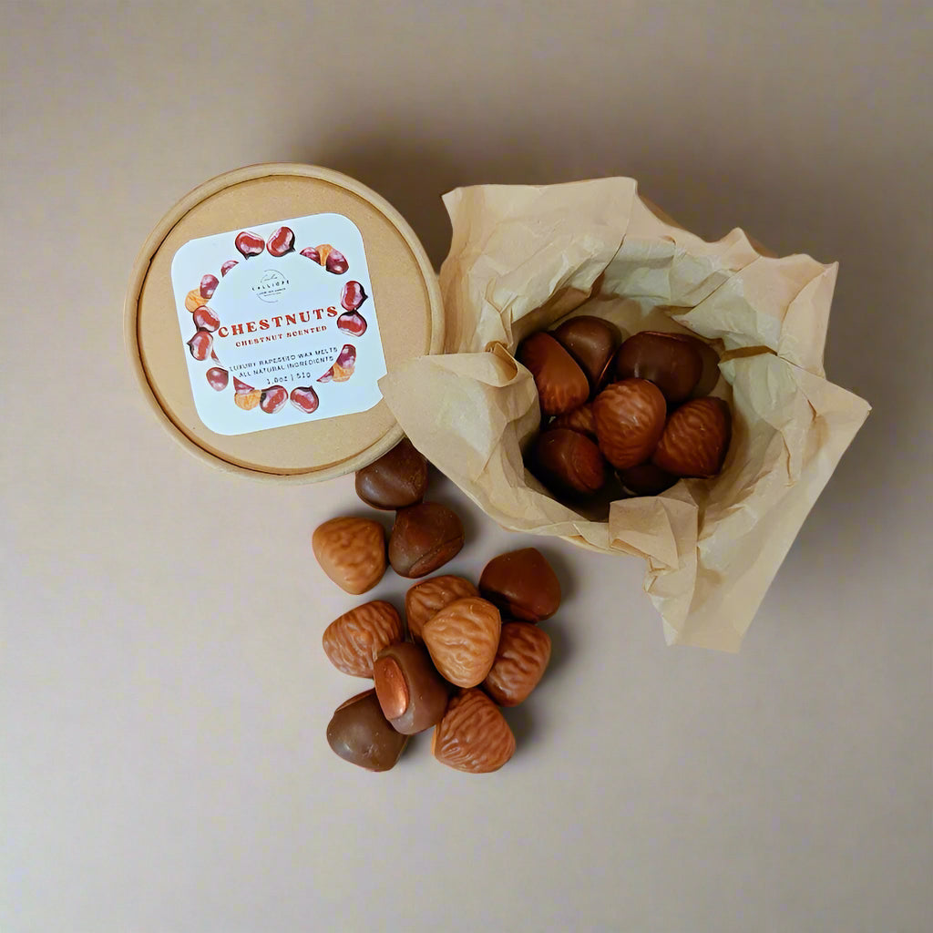 Chestnuts wax melts in a paper box and on a surface with a label on a beige background