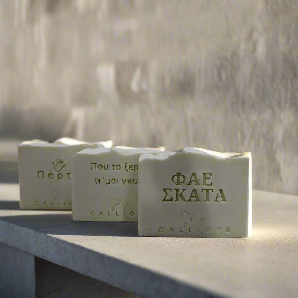 Three bars of soap with visible branding CalliopeShop on a light gray background