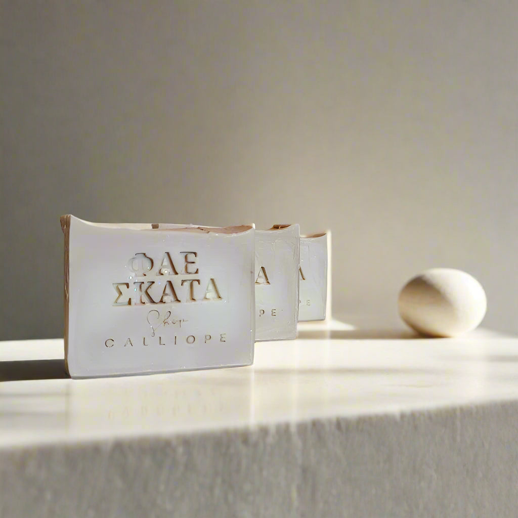 Three bars of soap with a simple design, placed on a light-colored surface, with the packaging showing the brand name ' Dirty Soap' in a minimalist style.