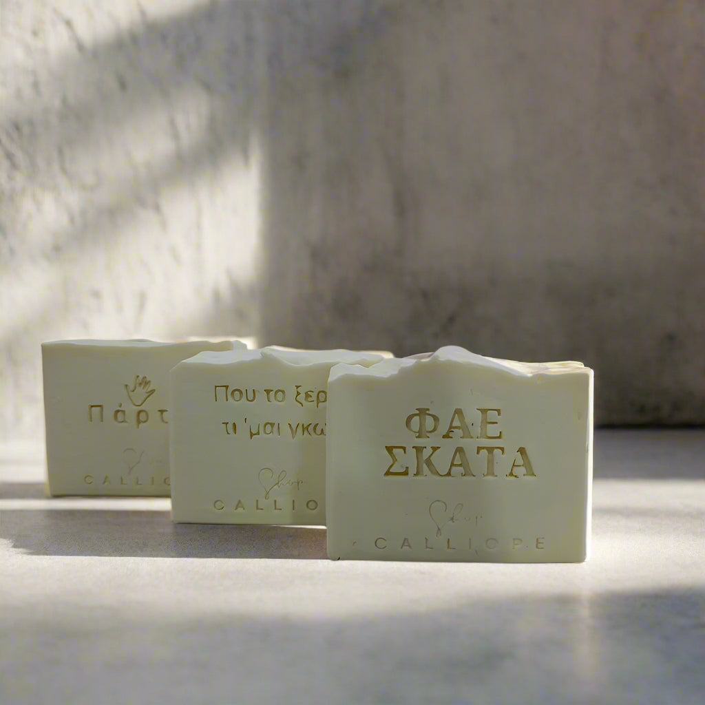 Three bars of soap with visible branding on a light background