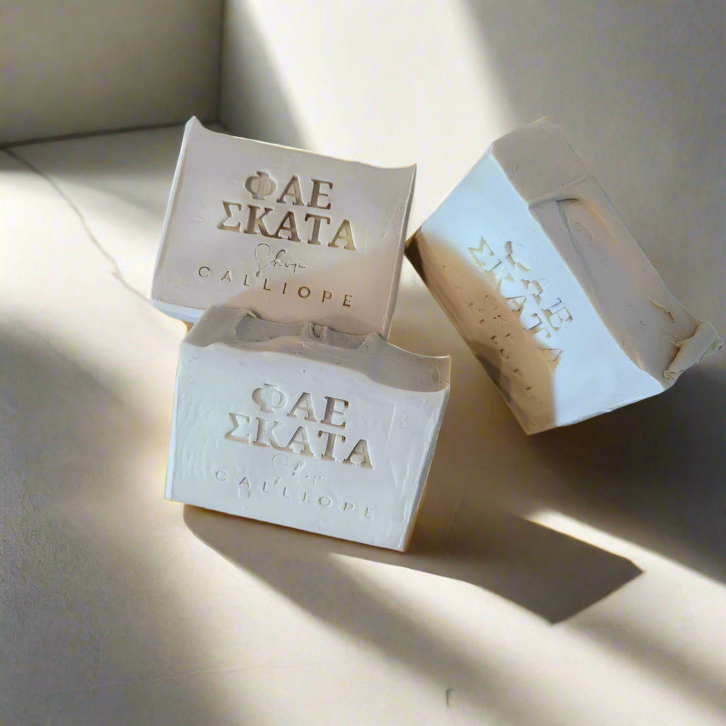 Three bars of soap with visible branding on a light background