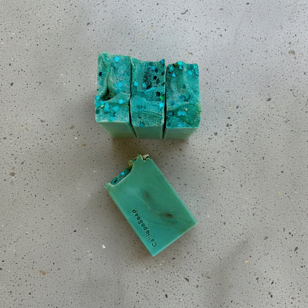 Green soap bars with a textured surface on a light gray background
