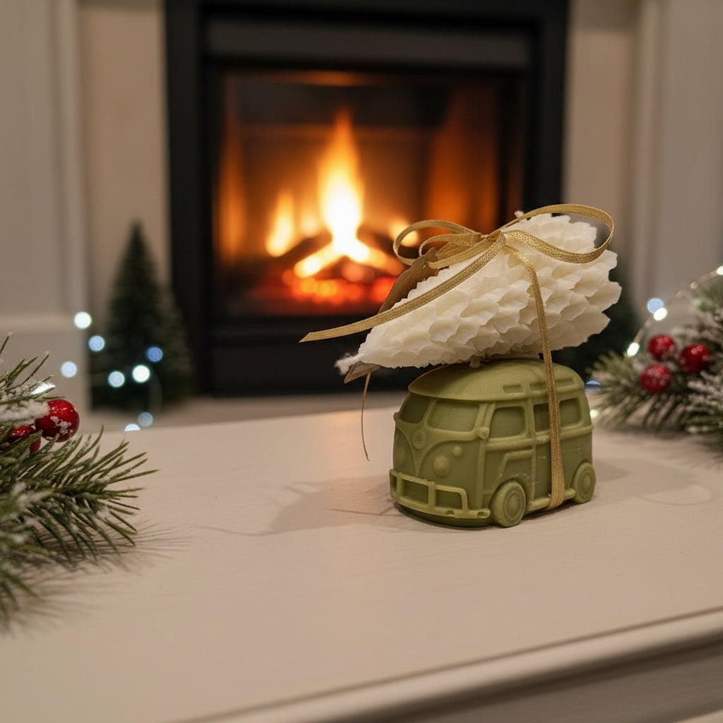Decorative item with a tree on top of a green vehicle model in front of a fireplace.