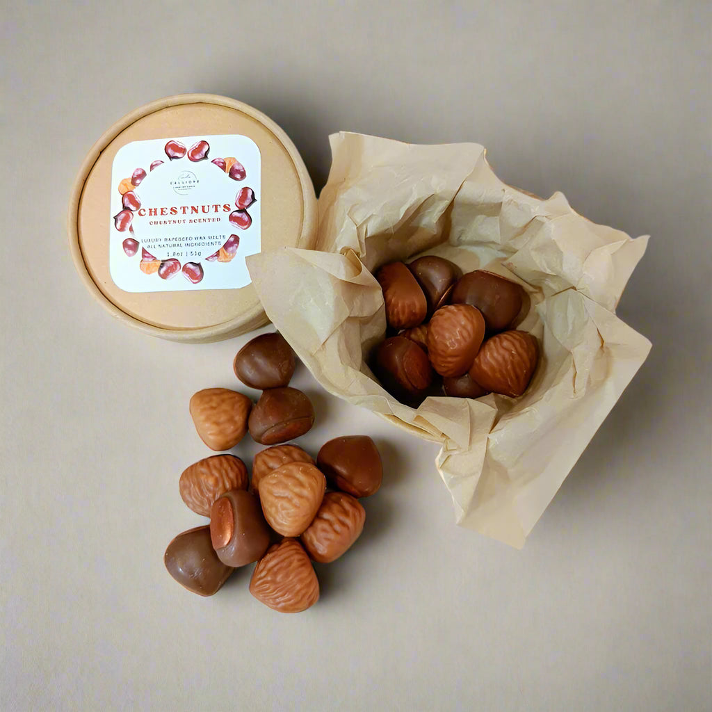 Chestnuts in a paper craft box and on a white surface with a label on a white background