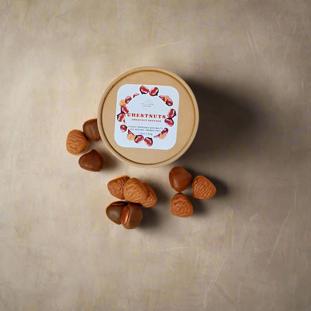 Paper craft container of chestnuts wax melts with a label on a light beige background
