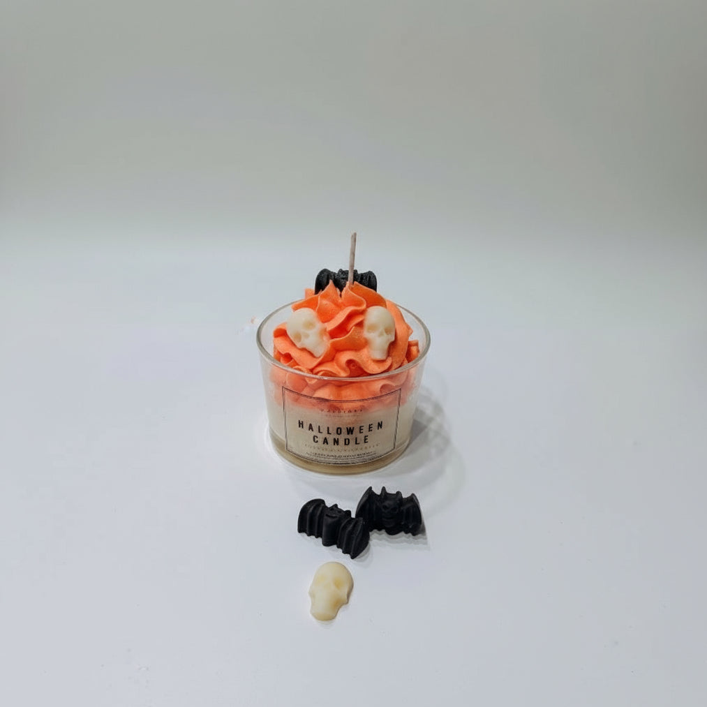 Halloween-themed candle with decorative elements on a white background