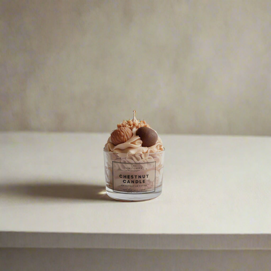 Candle with chestnut decorations on a white surface