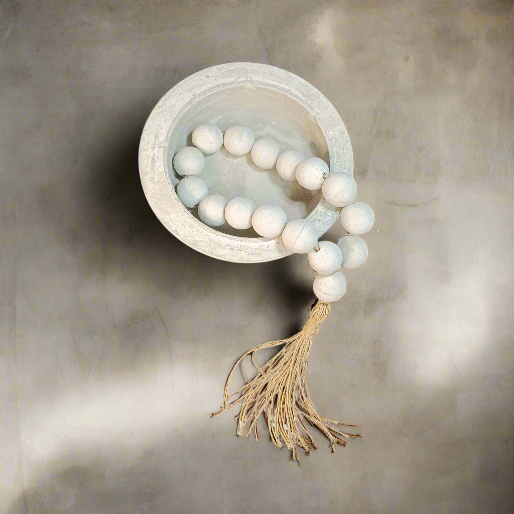 Greek komboloi with tassel in a concrete bowl
