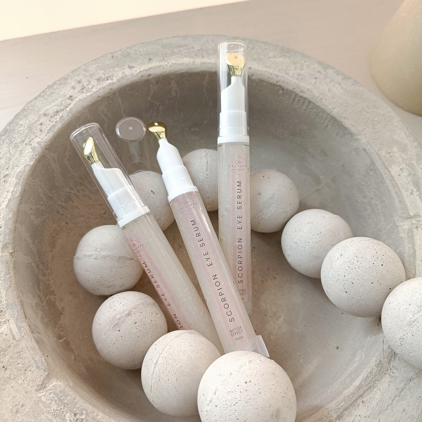 eye serum tubes in concrete bowl with concrete beads