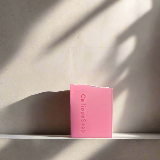 Pink bar of soap with 'Calliope Soap' branding on a white background