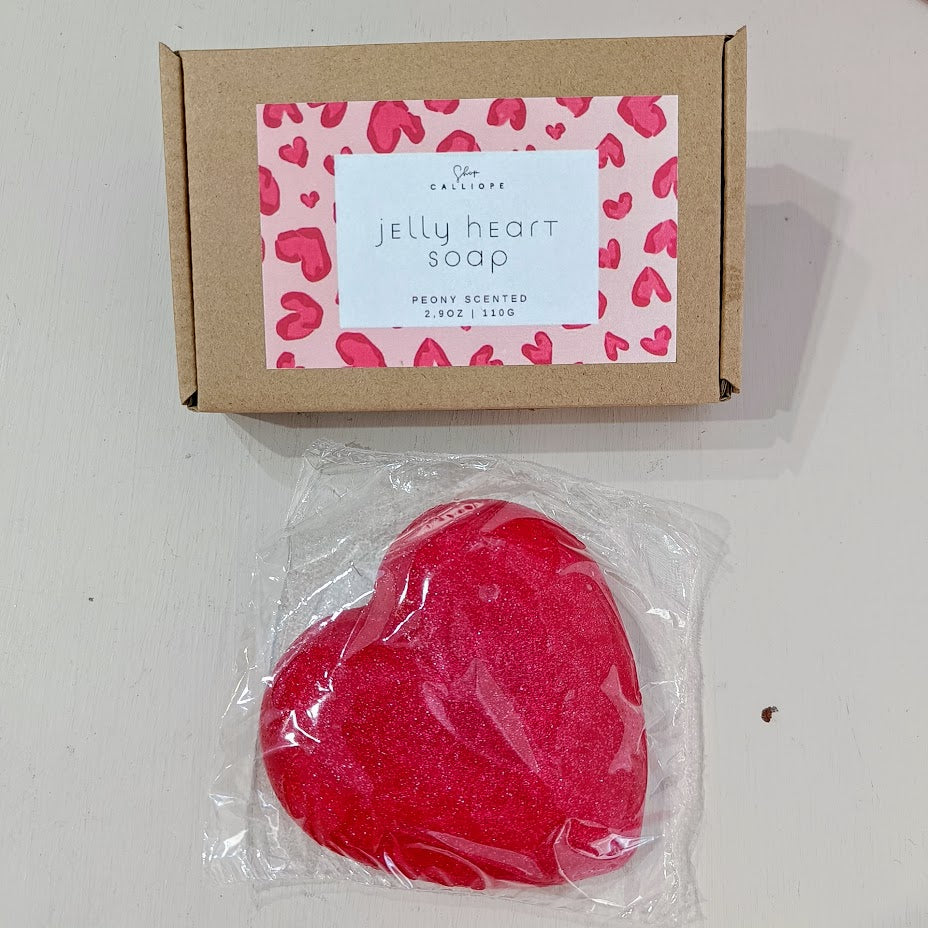 Red heart-shaped jelly soap in clear packaging with a cardboard box featuring a heart pattern.