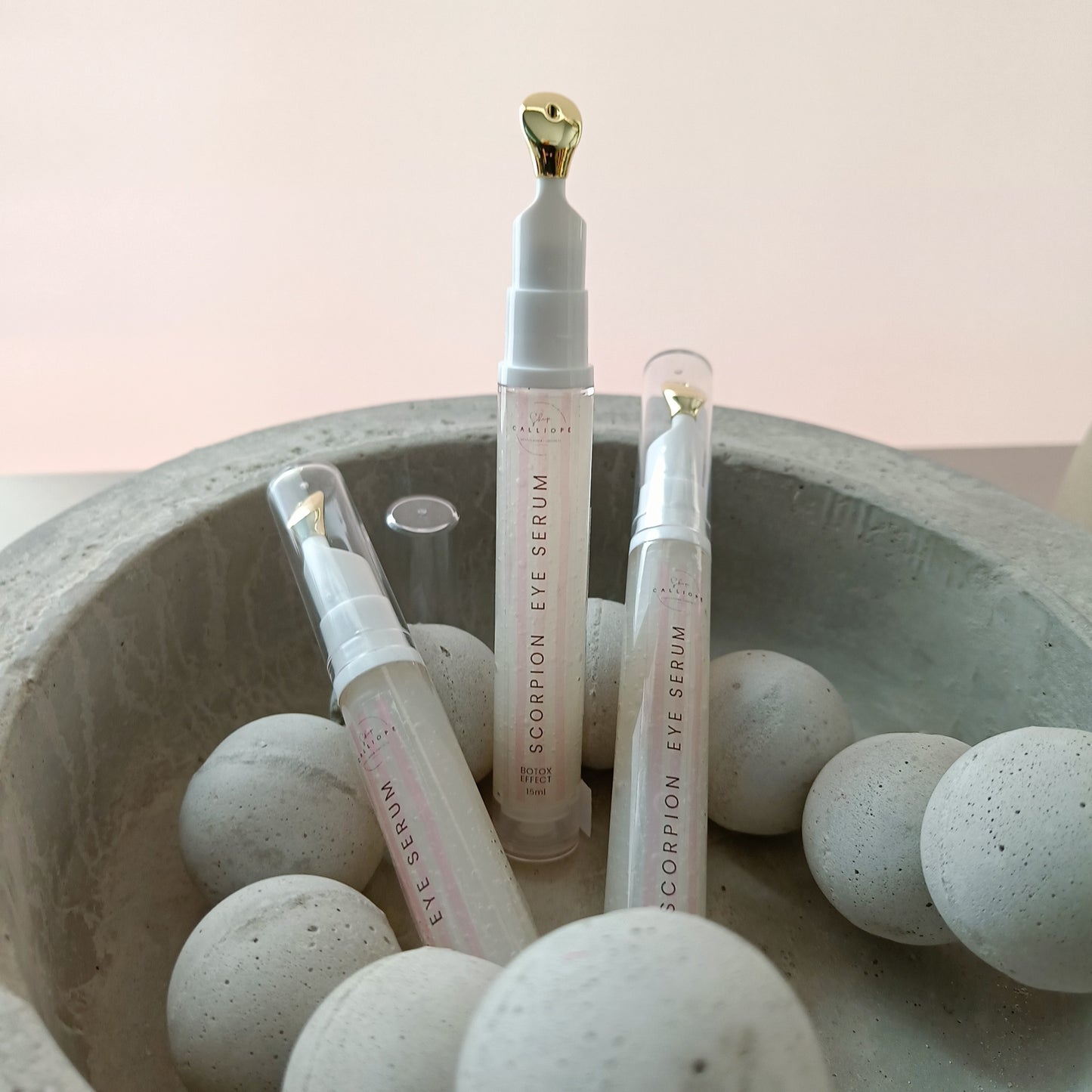eye serum tubes in concrete bowl with concrete beads