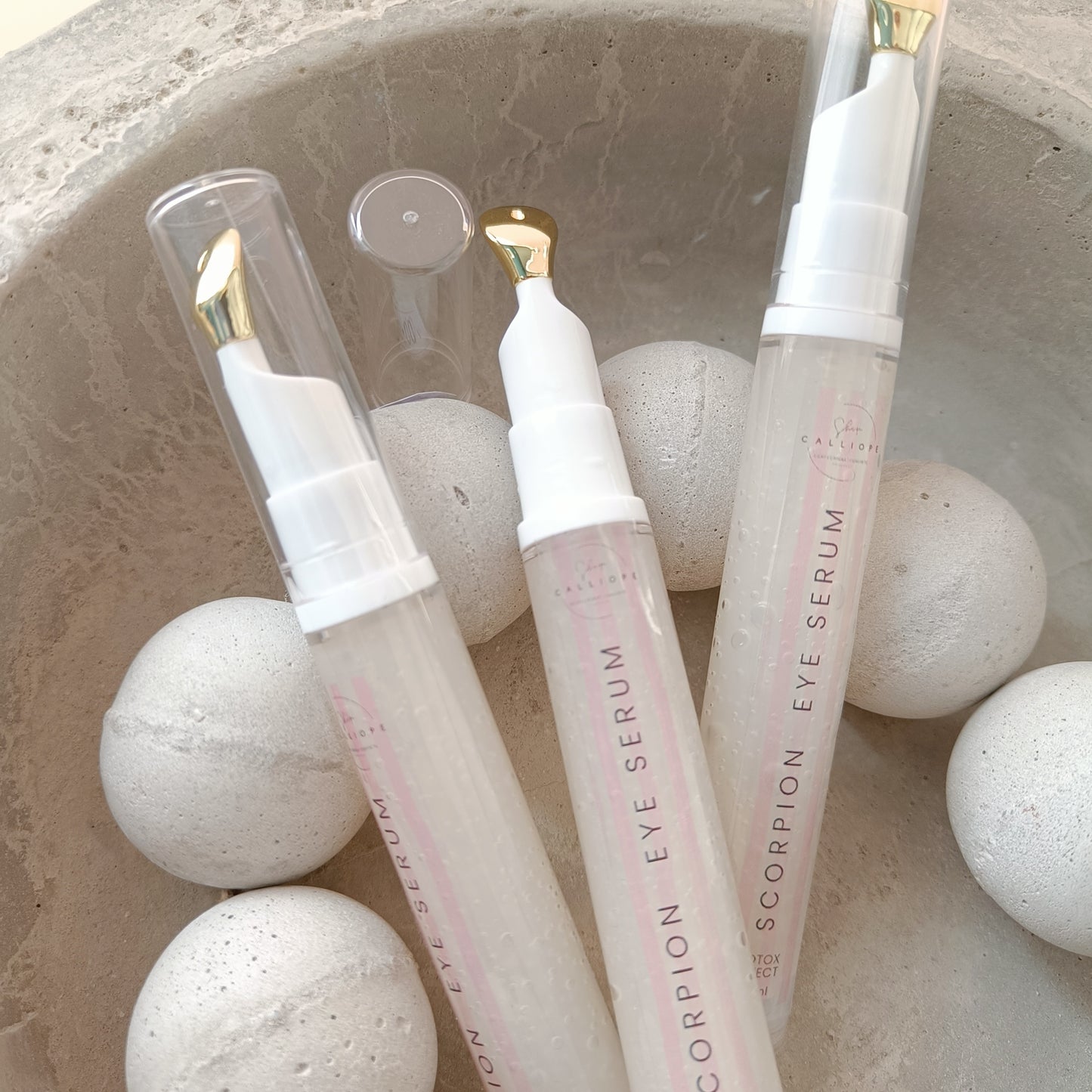 eye serum tubes in concrete bowl with concrete beads
