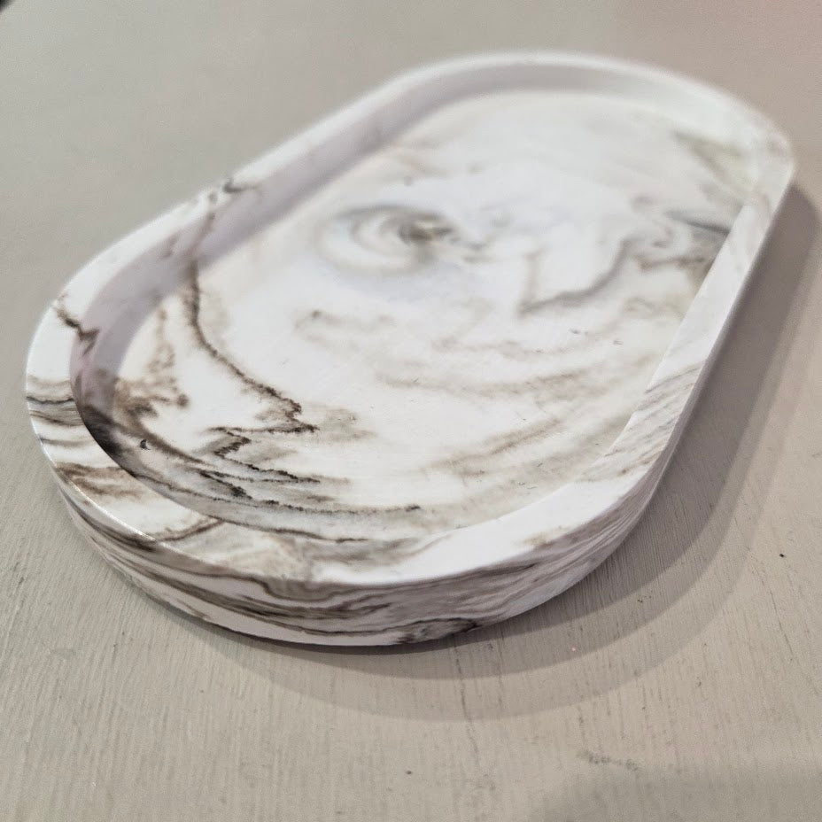 Marble-patterned dish on a light gray surface