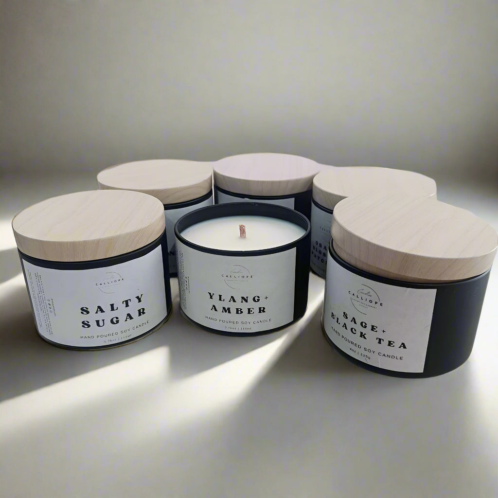 Set of candles with labeled containers on a white background
