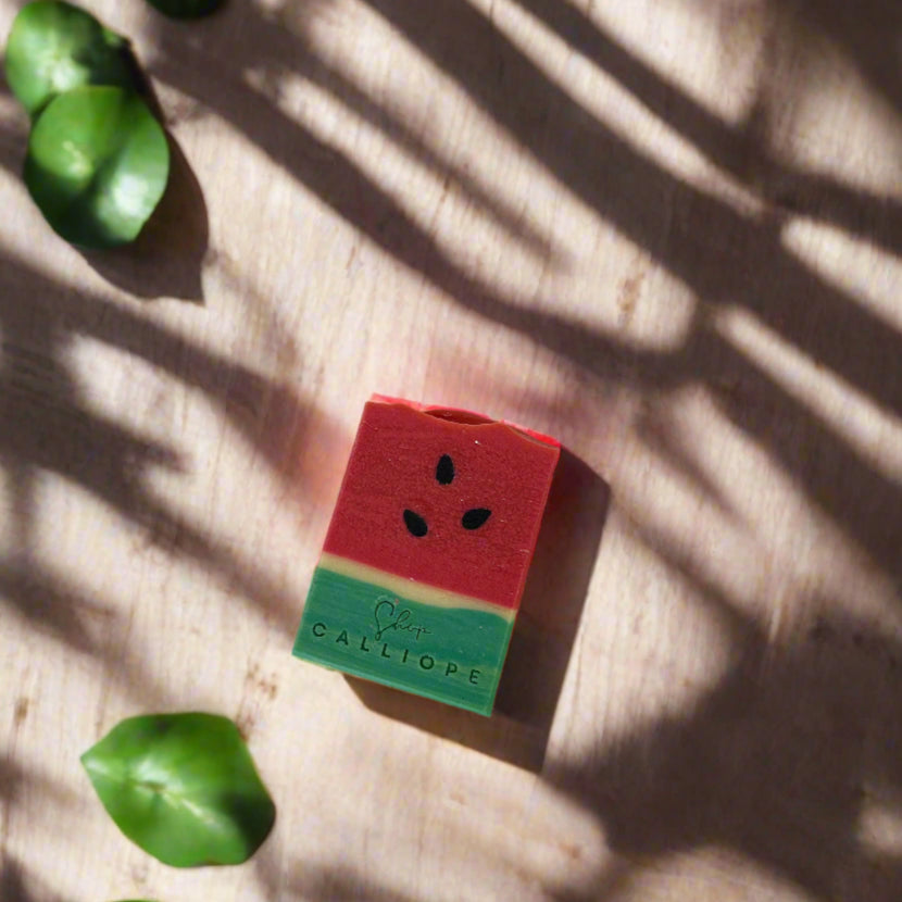Watermelon-themed pencil sharpener on a wooden surface with shadows