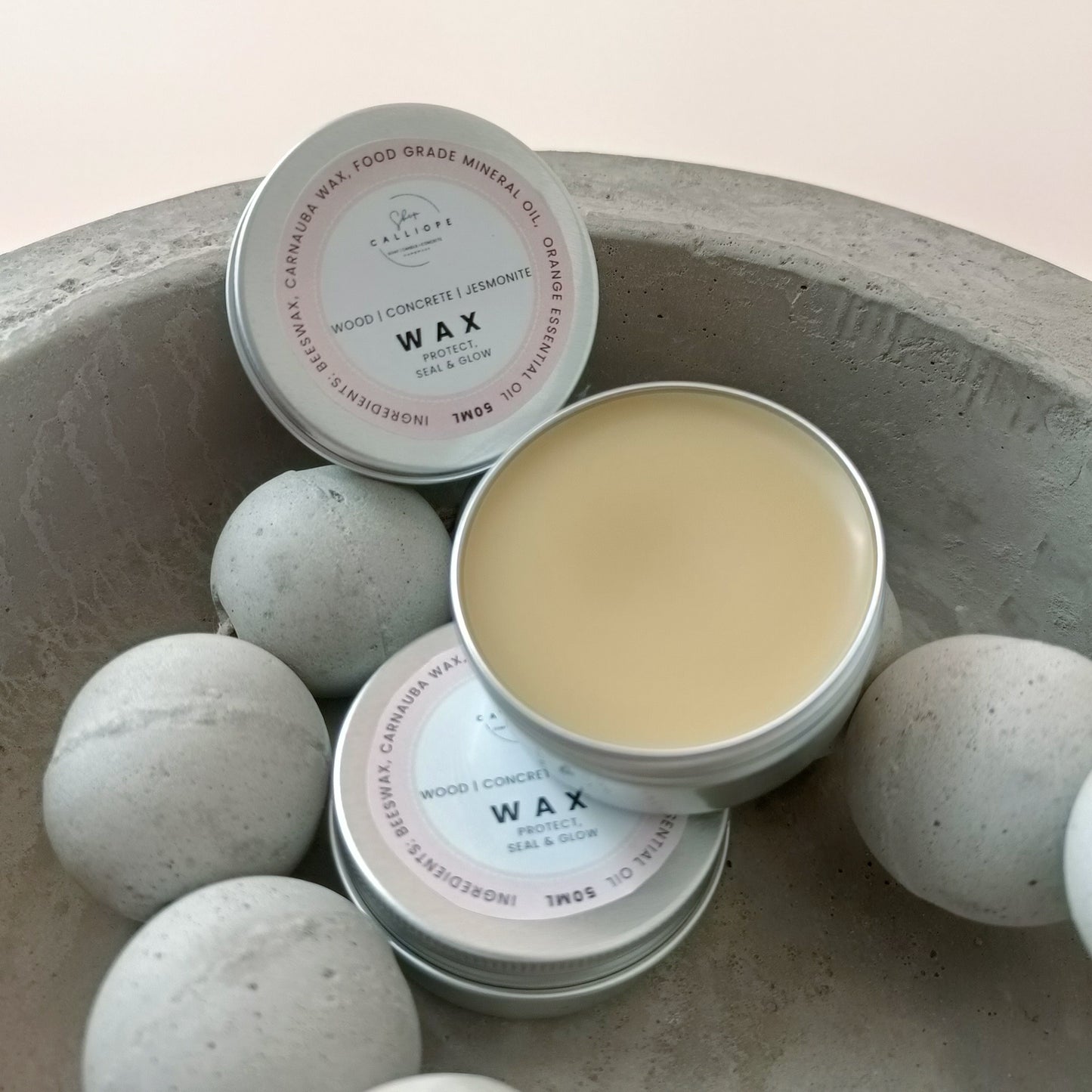 wax sealer tin container on concrete bowl with concrete beads