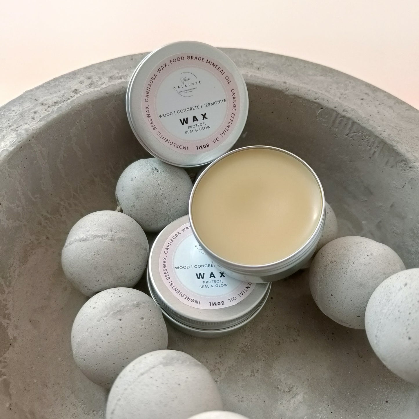 wax sealer tin container on concrete bowl with concrete beads