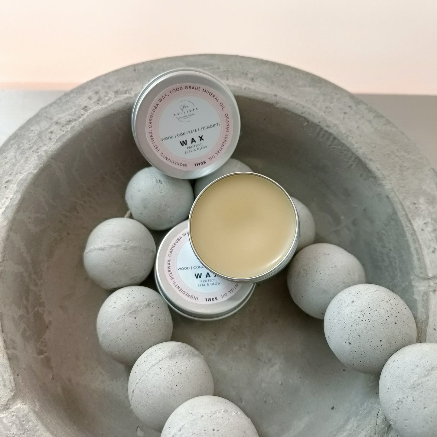 wax sealer tin container on concrete bowl with concrete beads