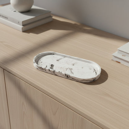 Decorative stone bowl on a wooden surface with books in the background