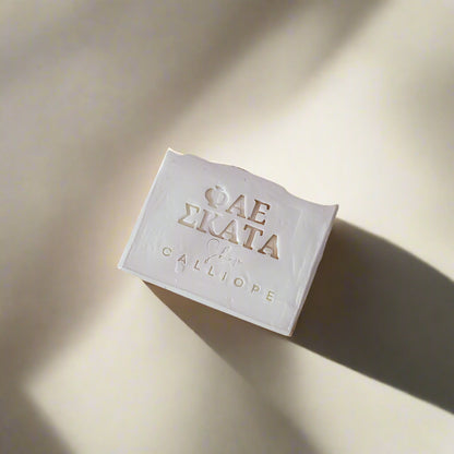 a white bar of soap with branding on a gray background