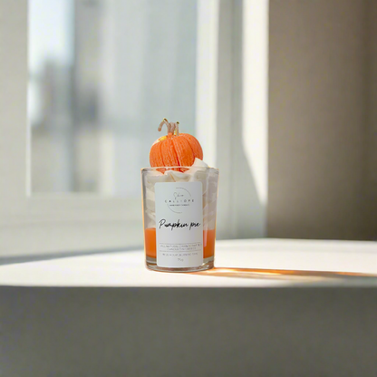 Candle shot with pumpkin decoration on a windowsill