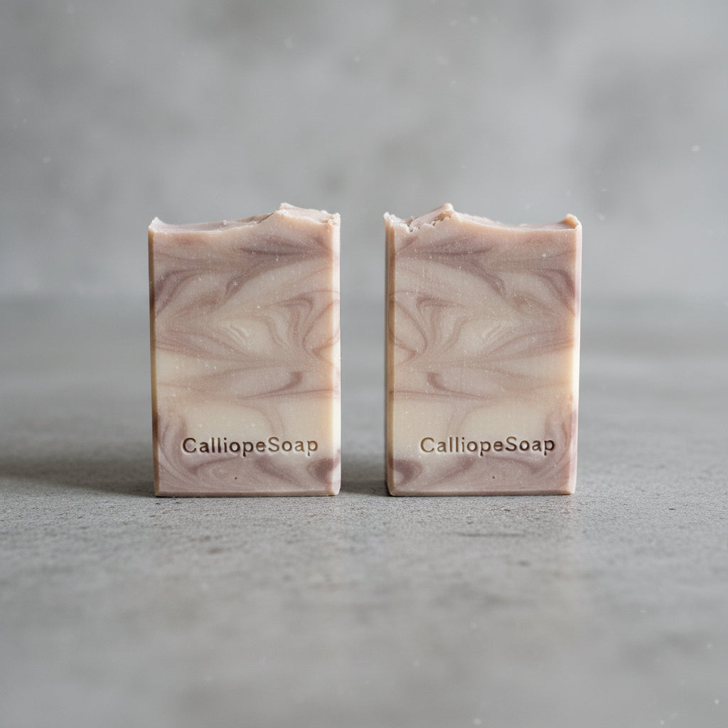 Handmade soap with CalliopeSoap stamp on a gray surface