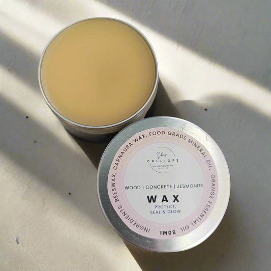 Tin of sealer wax with visible labels on a textured surface