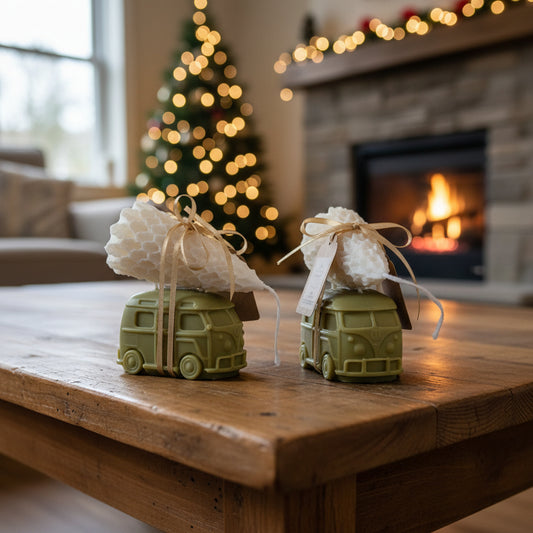 Two green toy cars with white cloths on a wooden table in a cozy living room with a Christmas tree and fireplace.