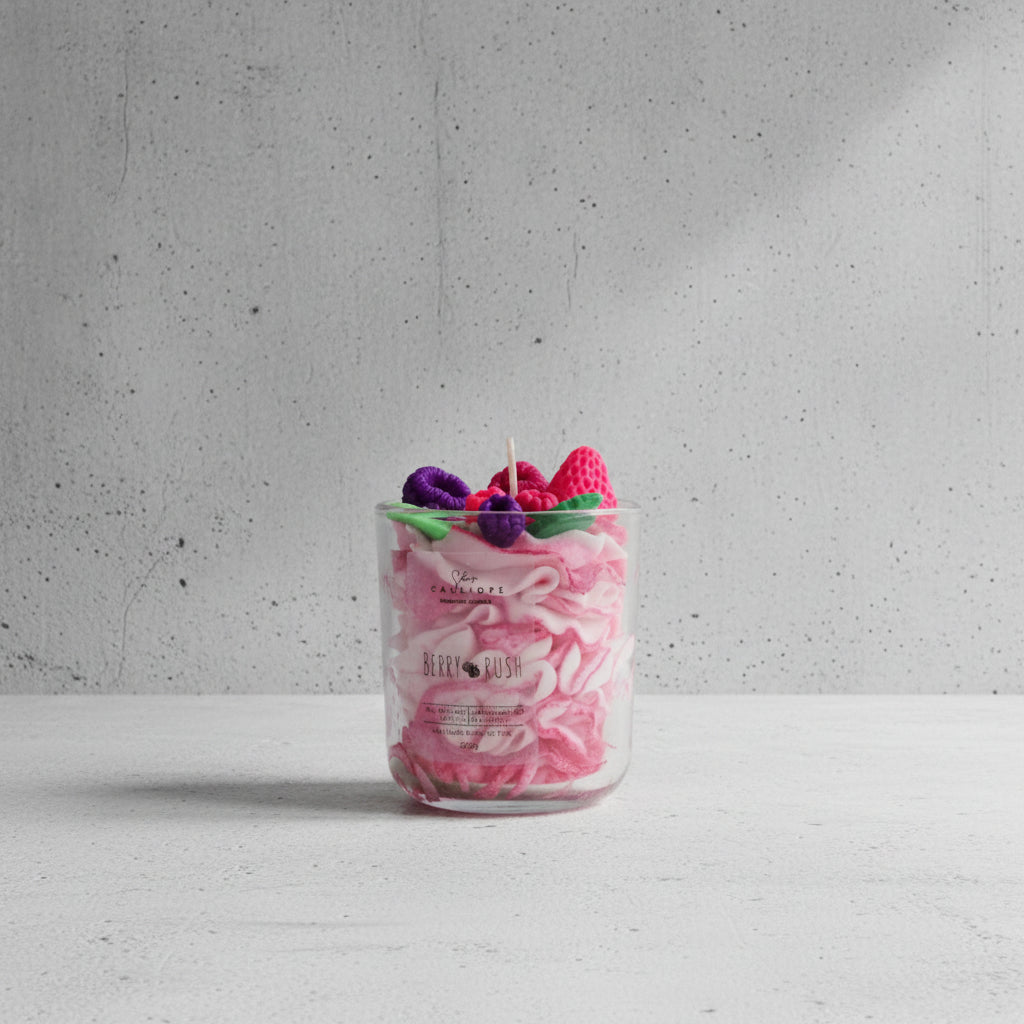 Candle in a glass jar with decorative elements on top, labeled 'Berry Rush'.