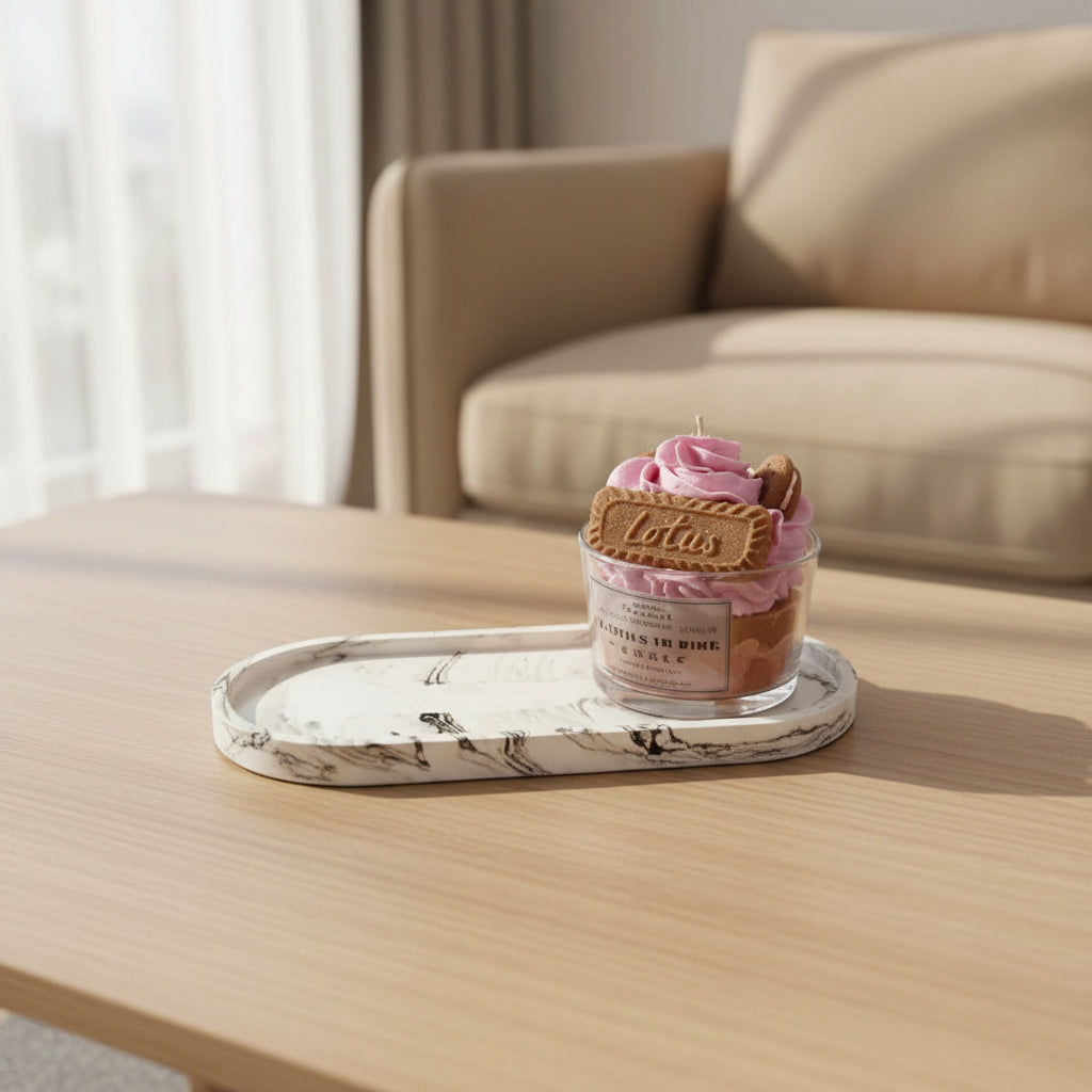 big oval tray with a candle on top, placed on a coffee table in front of a sofa 