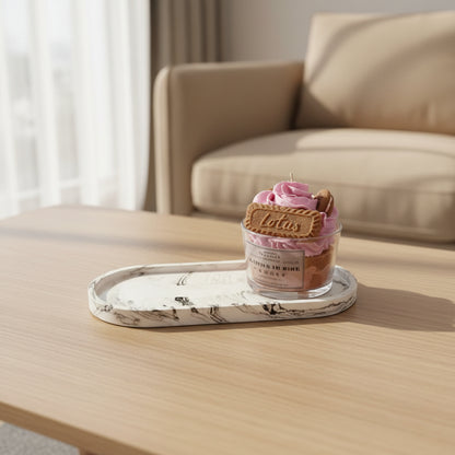big oval tray with a candle on top, placed on a coffee table in front of a sofa 