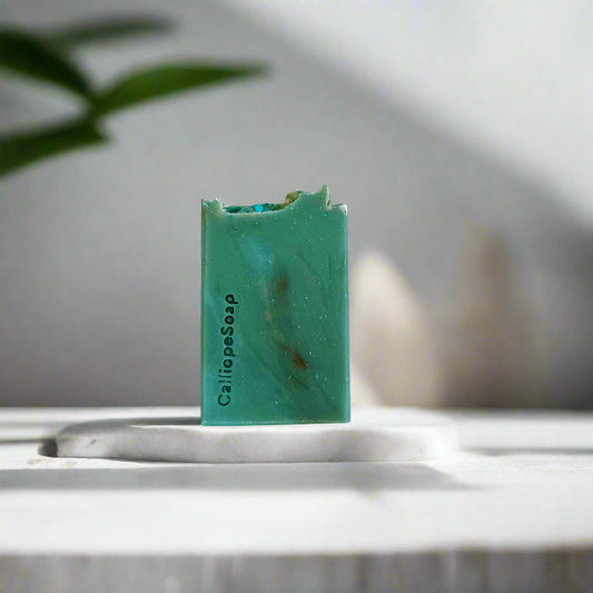 Green bar of soap with 'Calliope Soap' branding on a white background