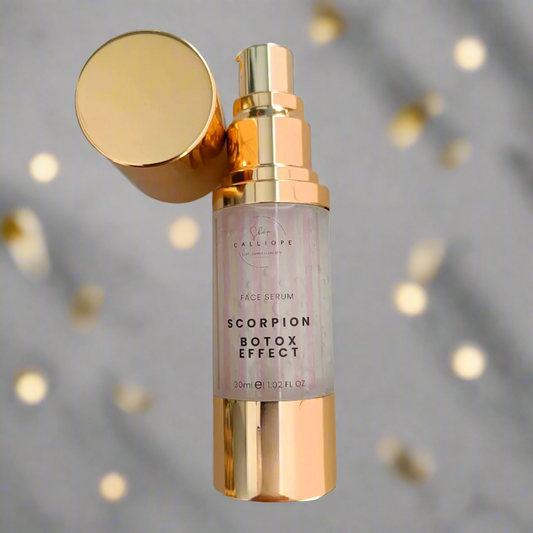A gold-colored bottle with a pump dispenser labeled 'Scorpion Botox Effect Serum' against a marble background with gold accents.