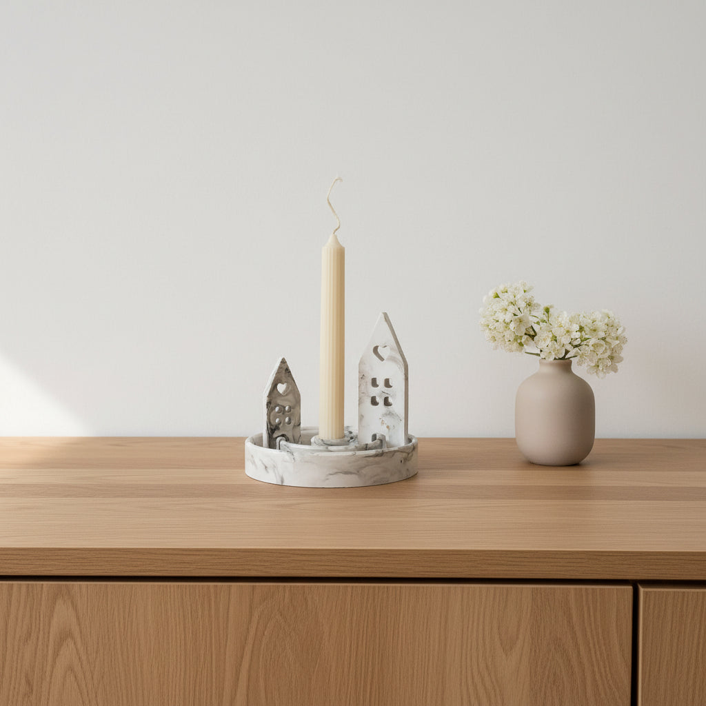 Wooden surface with a candle, decorative items, and a vase with flowers against a plain background