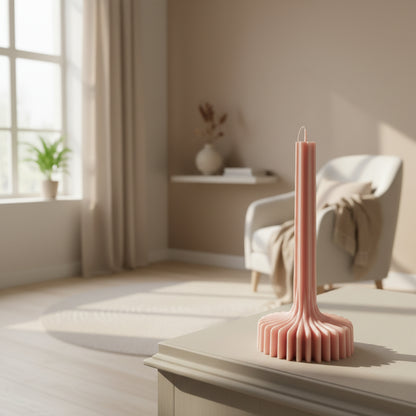 Pink candle holder with candles on a white surface
