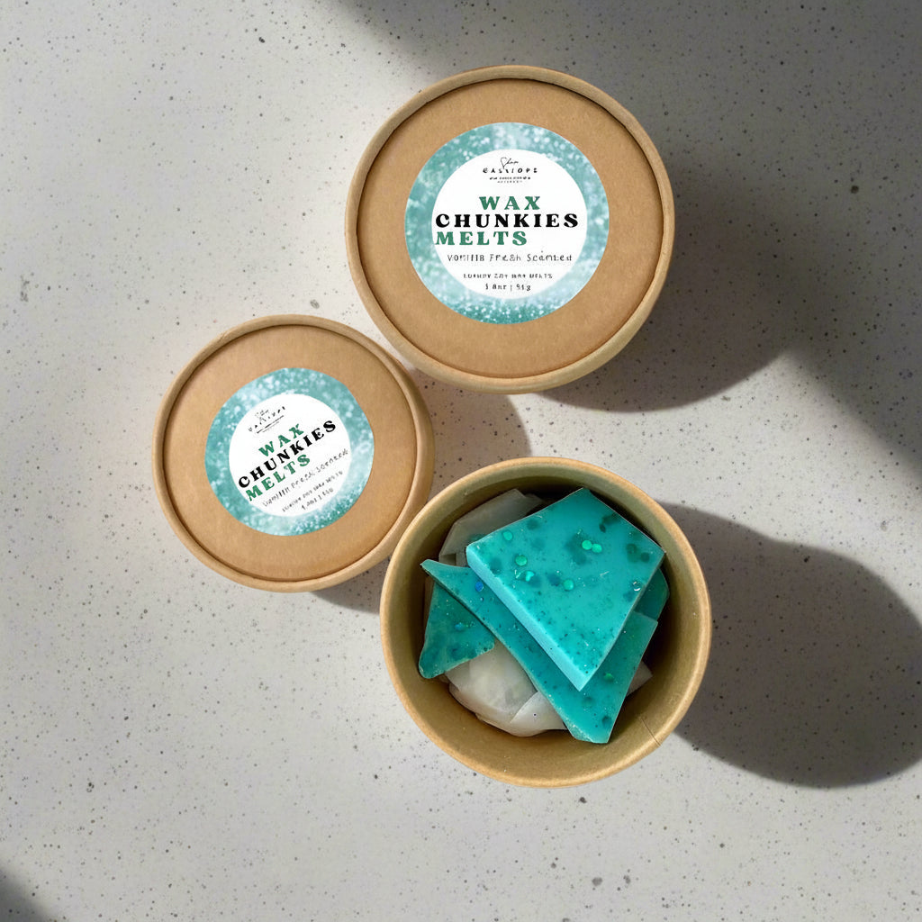 Wax chunkies melts in a cardboard container with a visible label on a light gray surface.