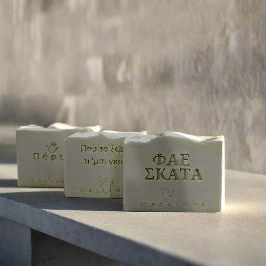 Three blocks of soap with visible branding on a light gray background