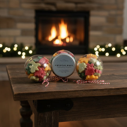 Decorative crystal balls with candy stars on a wooden table in front of a fireplace.