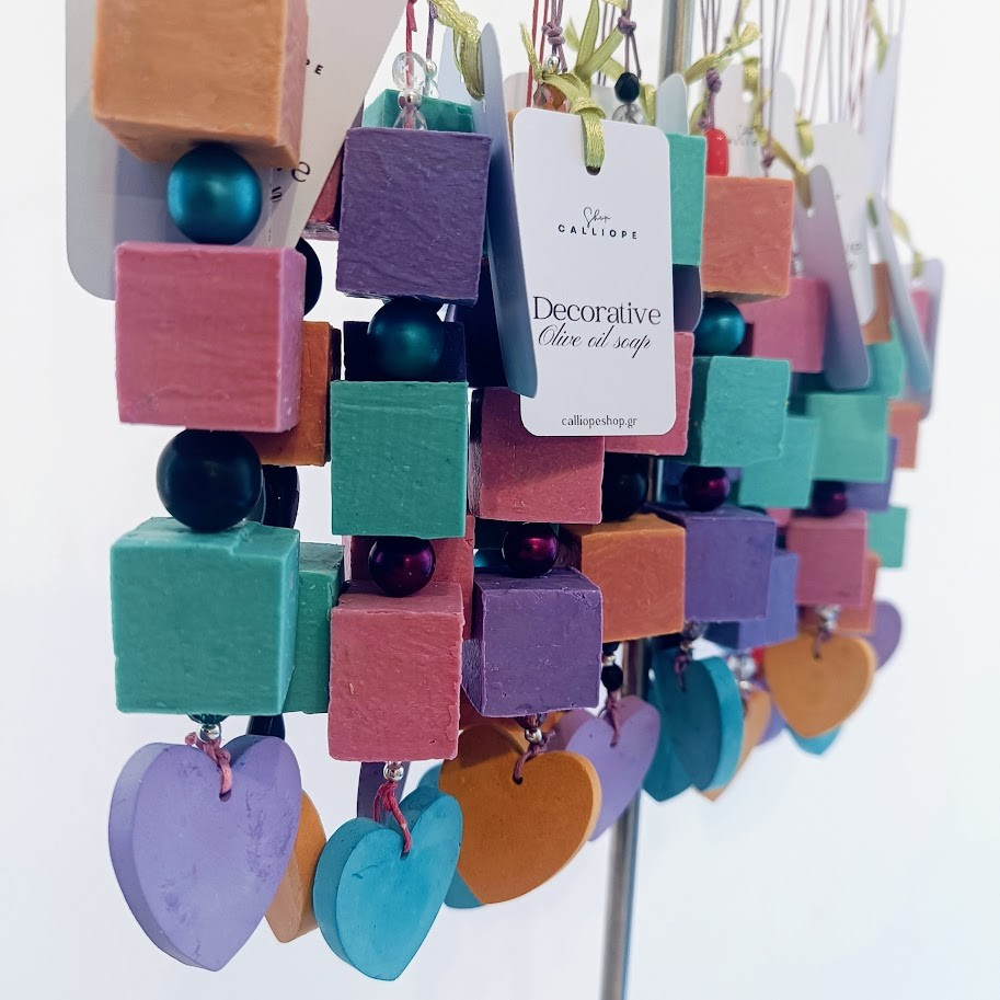 Colorful soap cubes on a stand with a visible brand label.